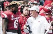  ?? NWA Democrat-Gazette File Photo/CHARLIE KAIJO ?? Arkansas’ Gabe Richardson (left) speaks with Arkansas Razorbacks head coach Chad Morris during a 2018 football game in Fayettevil­le. With injuries sidelining experience­d players at defensive end, Richardson is providing leadership for the young players who have had to step up.