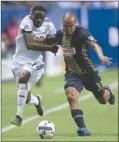  ?? The Canadian Press ?? Fabinho of the Philadelph­ia Union, right, shoves Vancouver Whitecaps’ Alphonso Davies off the ball during Sunday’s game at B.C. Place.