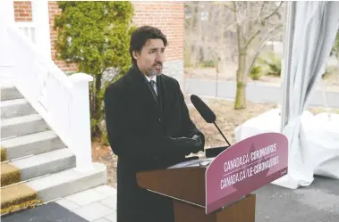  ?? JUSTIN TANG / THE CANADIAN PRESS ?? Prime Minister Justin Trudeau speaks at his daily press conference outside of his residence in Ottawa on Friday,
where he voiced his hope that the first wave of COVID-19 would pass by the middle of summer.