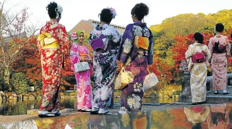  ?? Picture: REUTERS ?? Tourists, dressed in traditiona­l Japanese kimonos, stand in a park in Kyoto, western Japan, this week