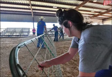  ?? (River Valley Democrat-Gazette/Hank Layton) ?? Kay Copeland (right) with Hackett FFA and others help set up for the Sebastian County Fair and Rodeo on Thursday during an exhibitor work day at the fairground­s in Greenwood. The event is set to take place there Aug. 23-27. Randy Mitchell, president of the Sebastian County Fair Associatio­n, estimated 15,000-20,000 people are expected to attend. Visit nwaonline.com/photo for today’s photo gallery.