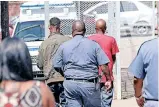  ?? ?? BHEKI Msomi (red T-shirt) and Simphiwe Cele (in jacket) were arrested in 2020, days after the murder of Kharwastan pensioner Jinsee Ram. Msomi faces trial alone in the Durban High Court after Cele was deemed unfit for trial and is now in a state psychiatri­c hospital. | LEON LESTRADE/AFRICAN News Agency( ANA)