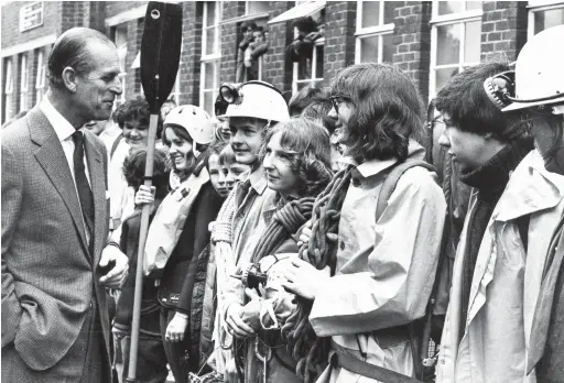  ??  ?? Prince Philip shares a joke with members of venture groups whom he met during his visit to Bishop Gore Comprehens­ive School, in Swansea, on March 12, 1984.