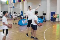  ?? MANISH SWARUP/AP ?? Kelly Olynyk coaches Indian children during a Basketball Without Borders camp on Wednesday. The Heat forward attended the camp in 2009 as a child.