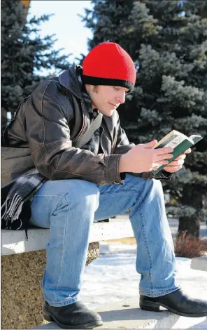  ?? Bruce Edwards, THE Journal ?? James Zaleski enjoys the mild weather, reading a book on the weekend.