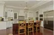  ??  ?? The kitchen contains pot lights, a coffered ceiling and chandelier.