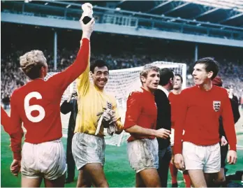  ??  ?? In safe hands...England goalkeeper Gordon Banks and skipper Bobby Moore hold aloft the World Cup in1966 at Wembley