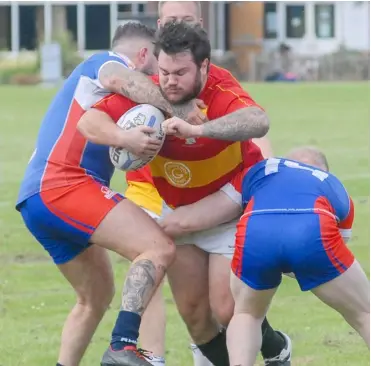  ?? Picture: Steve Smyth ?? Dan Jamieson being wrapped up by his former team mates