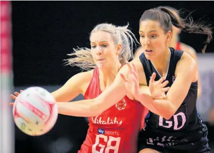  ?? Photos / Photosport ?? Karin Burger goes shoulder to shoulder with England’s Helen Housby.