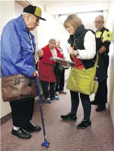  ?? TONY CALDWELL ?? Ottawa Public Health and Ottawa Search and Rescue check on seniors as they go through a building Monday on Viewmount Drive.