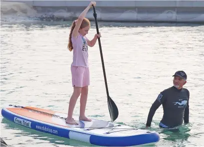  ??  ?? ROW TIME ... When boats are ready, why not trying to sail it for fun? It was fun time for this little girl during the Internatio­nal Boat Show.