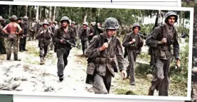  ??  ?? Above: Tattered and dirty members of Carlson’s Raiders pass by a unit of regular Marines after action on Talugi (US National archives)