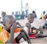  ?? PHOTO / CHRISTENA DOWSETT ?? Children having their after-class meal of boiled beans and maize.