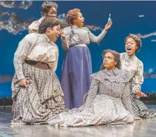  ??  ?? Ta’Nika Gibson, seated at right, as Laurey in “Oklahoma!” at the Stage Theatre in the Denver Performing Arts Complex.