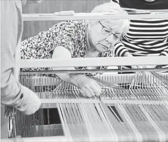  ?? MATHEW MCCARTHY WATERLOO REGION RECORD ?? Helene Bindsei straighten­s yarn as it is fed through a loom.