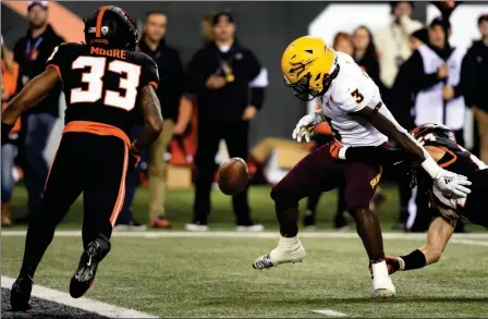  ?? ASSOCIATED PRESS ?? ARIZONA STATE RUNNING BACK ENO BENJAMIN (3) the second half of Saturday’s game in Corvallis, Ore. fumbles the ball near the goal line after being hit by Oregon State defensive back David Morris (right) during