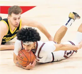  ?? JOHN J. KIM / CHICAGO TRIBUNE ?? Illinois guard Andre Curbelo makes a diving steal from Iowa guard Jordan Bohannon in the semifinal game in the Big Ten Tournament.