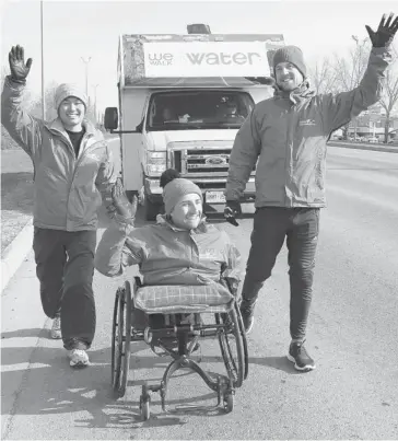  ?? Lorraine Hjalte/calgary Herald ?? West, with Alex Meers, left, and David Johnson, is travelling from Edmonton to Calgary, taking turns walking on his hands and in his wheelchair, to raise money for clean drinking water for Free The Children.