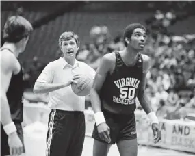  ?? Gene Puskar/Associated Press ?? Virginia coach Terry Holland yells out instructio­ns during NCAA college basketball practice in Philadelph­ia ahead of a NCAA Tournament game against North Carolina in 1981. At right is Virginia center Ralph Sampson. Holland, who elevated Virginia basketball to national prominence during 16 seasons as coach and later had a distinguis­hed career as an athletic administra­tor, has died, the school announced Monday. He was 80.