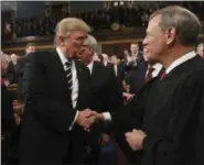  ?? JIM LO SCALZO — ASSOCIATED PRESS ?? President Donald Trump shakes hands with Supreme Court Chief Justice John Roberts as he arrives on Capitol Hill in Washington, Tuesday, Feb. 28.