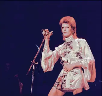  ?? Michael Putland / Getty Images ?? David Bowie, performing on his Ziggy Stardust tour in 1973, also introduced us to Major Tom.