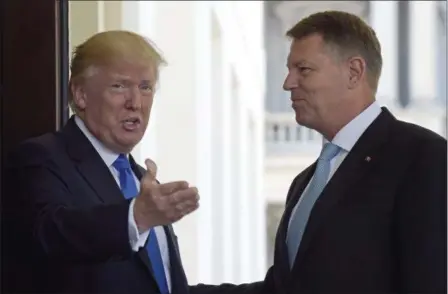  ?? SUSAN WALSH — THE ASSOCIATED PRESS ?? President Donald Trump welcomes Romania’s President Klaus Werner Iohannis to the White House in Washington, Friday.