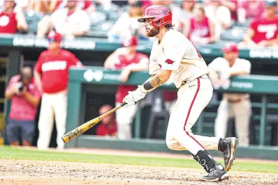  ?? (NWA Democrat-gazette/hank Layton) ?? Arkansas catcher Parker Rowland hits a two-run single May 14 during the fifth inning of the Razorbacks’ 5-1 win over the South Carolina Gamecocks at Baum-walker Stadium in Fayettevil­le.