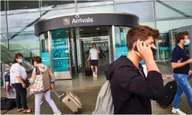  ??  ?? Passengers arriving at Stansted airport on Sunday after a 14-day quarantine was imposed on arrivals from Spain. Photograph: David Levene/The Guardian