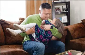  ?? JAMES C. SVEHLA PHOTOS / CHICAGO TRIBUNE / TNS ?? Irwin Obispo plays with Ava, 3, in their home in Orland Hills, Ill. Ava was born premature.