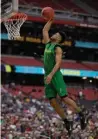  ?? Associated Press ?? n Oregon's Tyler Dorsey dunks during a practice session for their NCAA Final Four tournament college basketball semifinal game Friday in Glendale, Ariz.