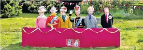  ?? ?? Scarecrows depicting the Royal family in the village of Sheriffhal­es, Shifnal, Shropshire, above. Below: Cutouts of the late Queen and the King added to colourful scenes on The Mall