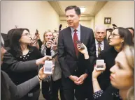  ?? Chip Somodevill­a / Getty Images ?? Former FBI Director James Comey is surrounded by reporters after testifying to the House Judiciary and Oversight and Government Reform committees at the Rayburn House Office Building on Capitol Hill on Friday in Washington.