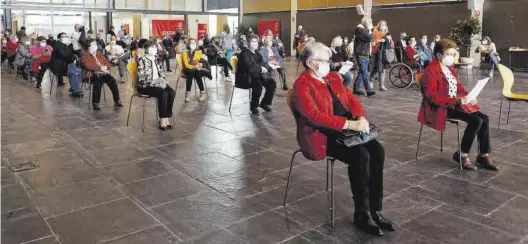  ?? ERIC PRADAS ?? Un grupo de personas espera en la sala habilitada en el Auditori de Castelló tras haber recibido una dosis de la vacuna de Pfizer durante la tarde de ayer.