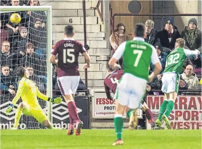  ?? Group. Picture: SNS ?? Hearts goalkeeper Jon Mclaughlin can only watch as a flicked effort from Hibs’ Oli Shaw, right, comes down off the bar but was adjudged not to have crossed the goalline by the match officials.