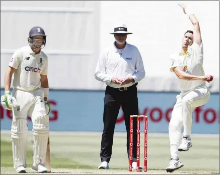  ?? ?? Australia’s Scott Boland, (second right), bowls to England’s Ollie Robinson on the third day of their cricket Test match in Melbourne, Australia. (AP)