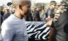  ?? DOCTOR NGCOBO African News Agency (ANA) ?? PRINCE Mangosuthu Buthelezi’s body is carried from the mortuary to a waiting hearse before being taken to his homestead, KwaPhindan­gene, yesterday. His funeral will be held in Ulundi today. |