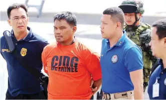  ??  ?? ARRESTED – Bangsamoro Islamic Freedom Fighters (BIFF) leader Ustadz Mohammad Ali Tambako is escorted by operatives of the Philippine National Police-Criminal Investigat­ion and Detection Group (PNPCIDG) as he arrives at the Villamor Air Base in Pasay...