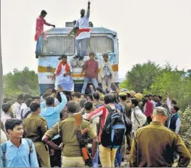  ?? PTI ?? Members of Akhil Bharatiya Kshatriya Mahasabha stop Sarnath Express train as police officers watch during a protest against Sanjay Leela Bhansali's film Padmavati in Allahabad on Thursday.