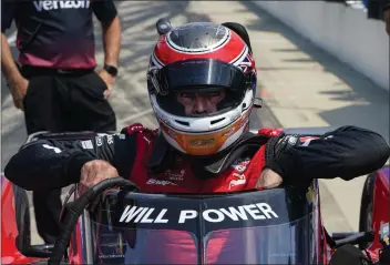  ?? MICHAEL CONROY — THE ASSOCIATED PRESS ?? Will Power climbs into his car during practice for the Indy 500 at Indianapol­is Motor Speedway on Friday.