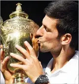  ?? The Associated Press ?? Novak Djokovic of Serbia kisses the trophy after defeating Kevin Anderson of South Africa in the men's singles final match at the Wimbledon Tennis Championsh­ips in London, Sunday.