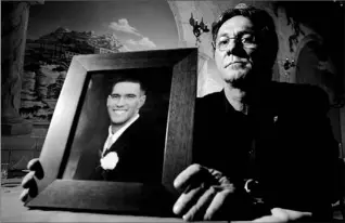  ?? BERNARD WEIL/TORONTO STAR ?? Joe Manchisi holds a photo of his son, Joe, 20, who along with a friend, was murdered and then dismembere­d by convicted pedophile Douglas Moore on Nov. 12, 2003. A teenage boy who admitted to helping Moore says he cannot remember where the murdered...