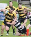  ??  ?? Lochaber’s Connor Taylor, who scored two tries, batters through the Mull defence.