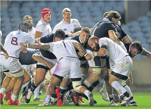  ??  ?? Above: Scotland’s forwards create the space for captain Fraser Brown to go in for the first of his two tries; right: Finn Russell congratula­tes Duhan van der Merwe after the debutant scored his first try for Scotland.