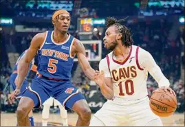  ?? Tony Dejak / Associated Press ?? Cleveland Cavaliers' Darius Garland (10) drives against New York Knicks' Immanuel Quickley (5) in the first half on Monday.