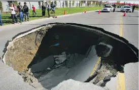  ?? RYAN JACKSON ?? Several large sinkholes have captured Edmonton’s attention in the past. In 2007, Deborah Shinkaruk-Hobbs and her children were driving northbound on Lessard Drive near 54 Ave. in Edmonton when they felt the ground shake. The road behind them had...
