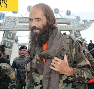  ?? NICKEE BUTLANGAN / THE ASSOCIATED PRESS ?? Released Norwegian hostage Kjartan Sekkingsta­d readies to board a plane to take him to Davao city after his release from captivity in September 2016 by Abu Sayyaf militants in the Philippine­s.