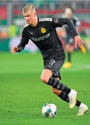  ?? AFP ?? Dortmund’s Erling Braut Haaland runs with the ball during their German League match against Augsburg in Augsburg on Saturday. Dortmund won 5-3. —