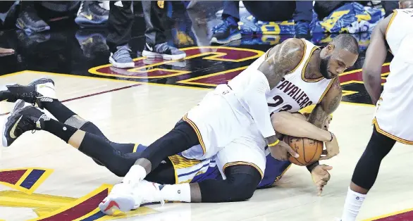  ?? JASON MILLER/GETTY IMAGES ?? Cleveland Cavaliers forward LeBron James tries to rip the ball away from Golden State Warriors centre JaVale McGee in Game 3 on Wednesday in Cleveland.