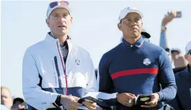  ?? Photo / AP ?? Jim Furyk (left) and Tiger Woods size up Le Golf National.