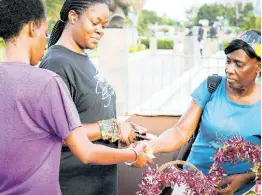  ?? ?? Members of the public received give-away items during their tour of booths at WMW Jamaica’s WE Talk FACTSS (‘Fostering A Culture Towards Safety & Support’) campaign launch at Emancipati­on Park.